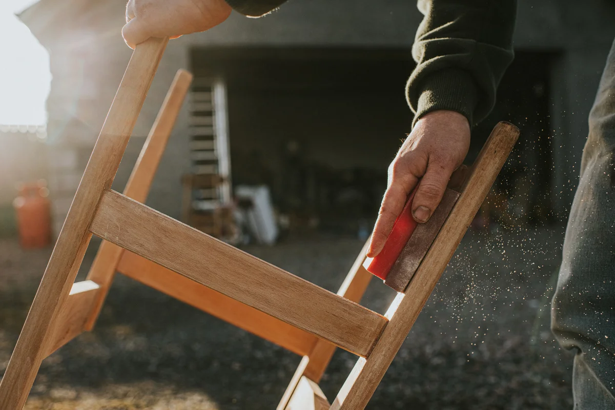 Man building and sanding a chair