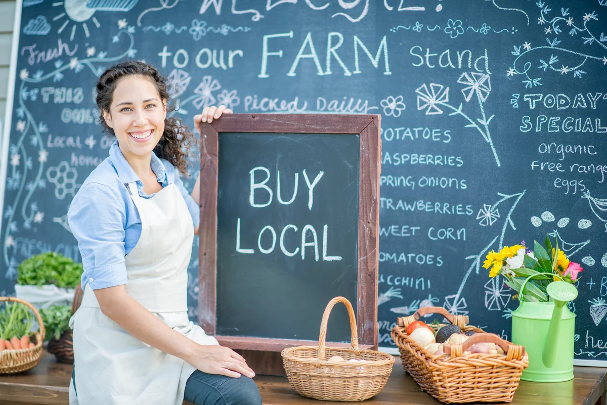 Woman holding a DIY chalkboard at Farmer's Market