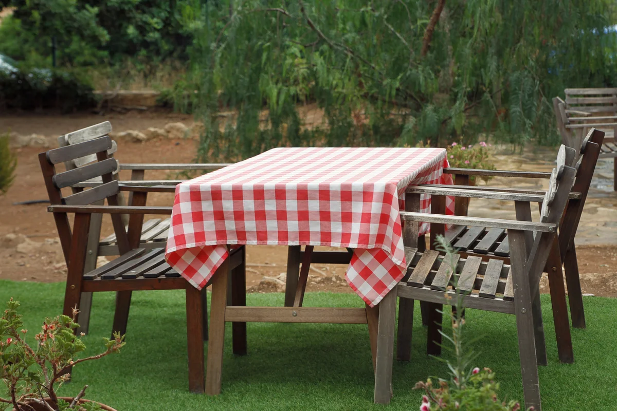 Picnic table covered in checkered table cloth