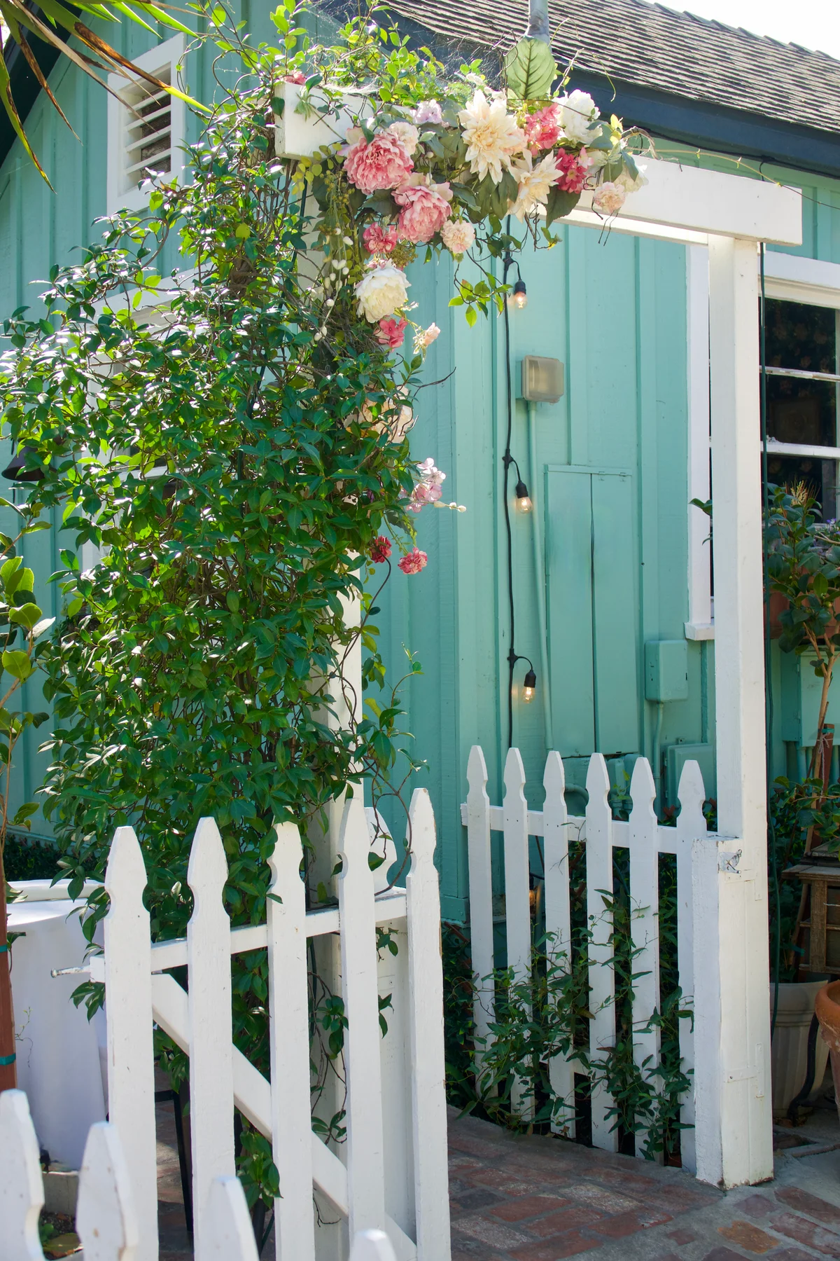 Old door frame repurposed into white garden trellis