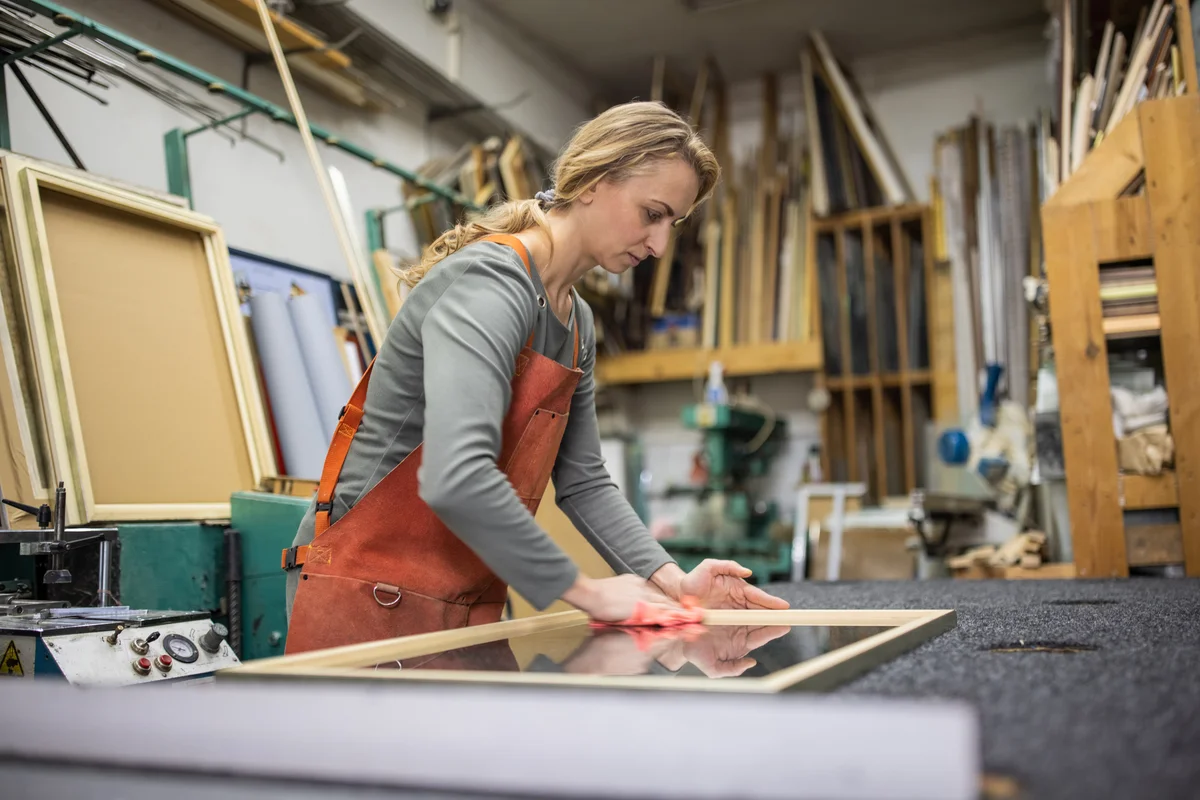 Woman building picture frame