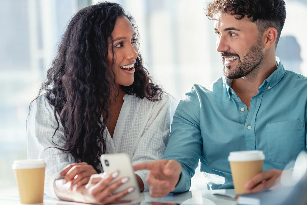 Businessman and businesswoman looking at a mobile phone