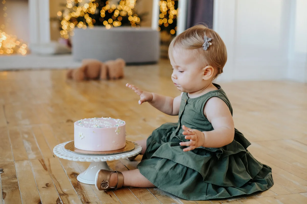 girl in a green dress with a cake