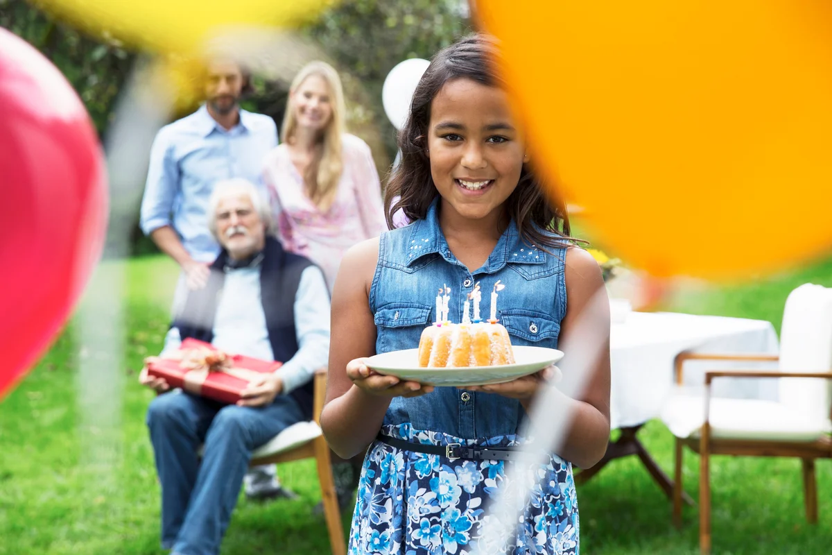 girl with a small birthday bundt cake