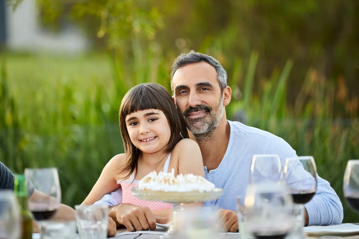 father and daughter posing for photo