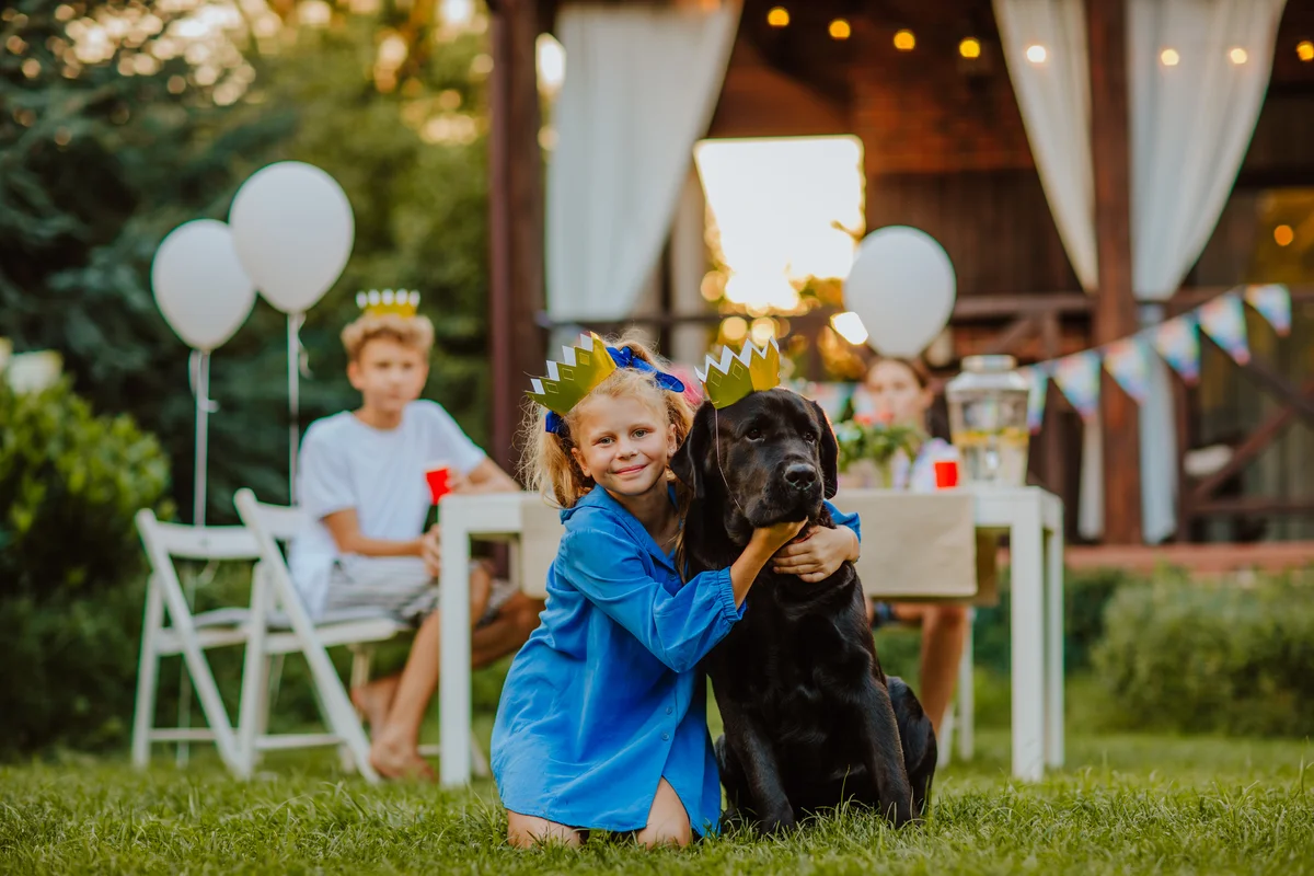 girl and dog wearing golden birthday crowns