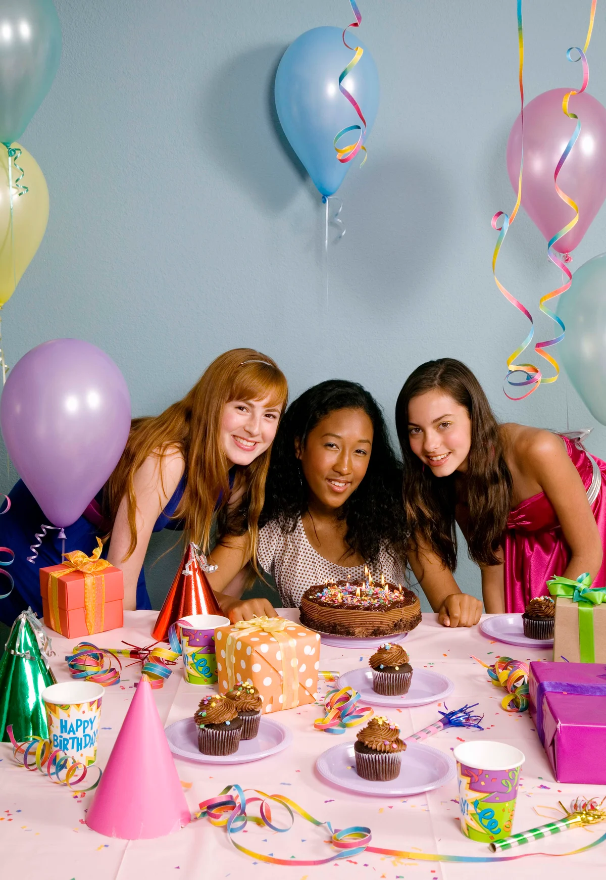 Three teen girls in a posed birthday photo