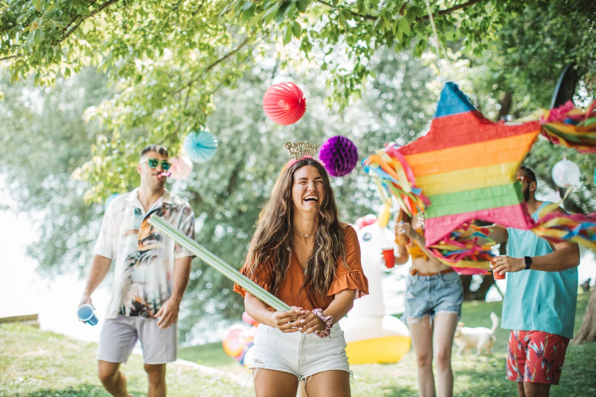 woman hitting a birthday pinata