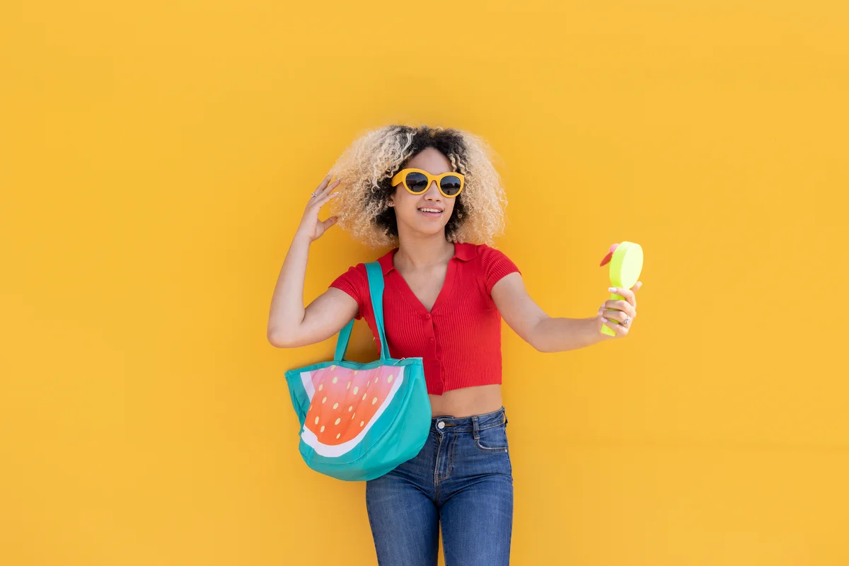 woman holding a portable fan