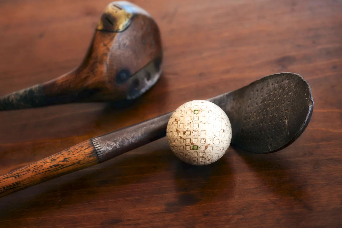 Antique golf clubs and golf ball