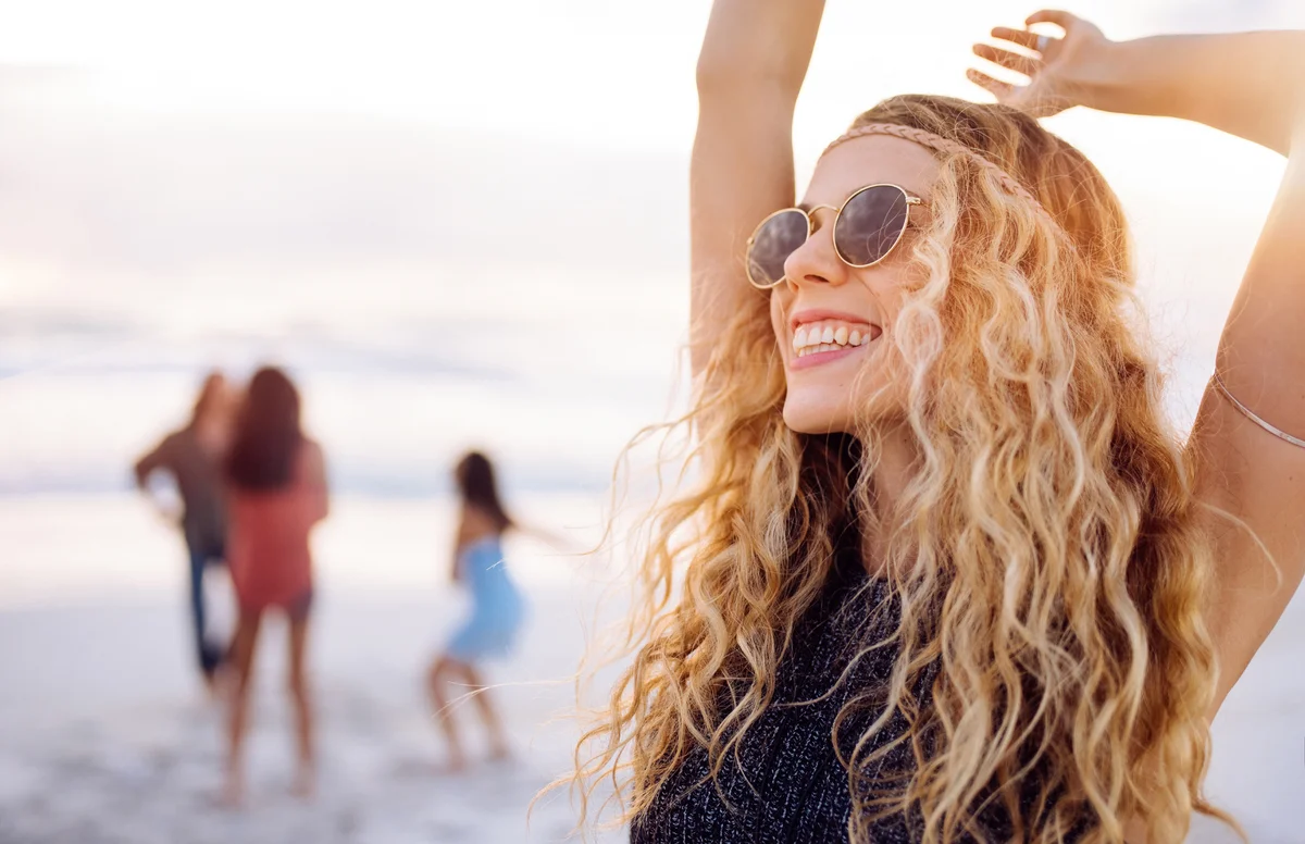 Boho woman dancing on beach