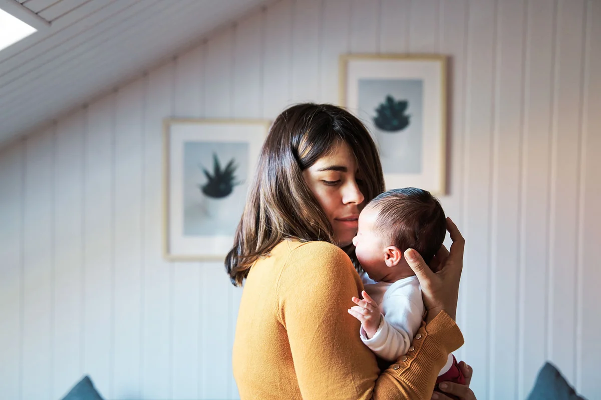 mother comforting her newborn while crying