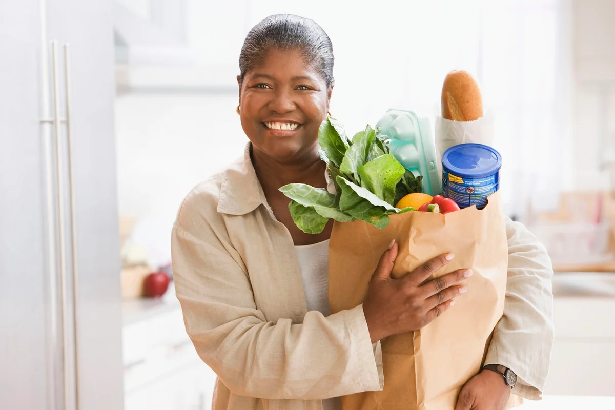woman holding a bag of groceries