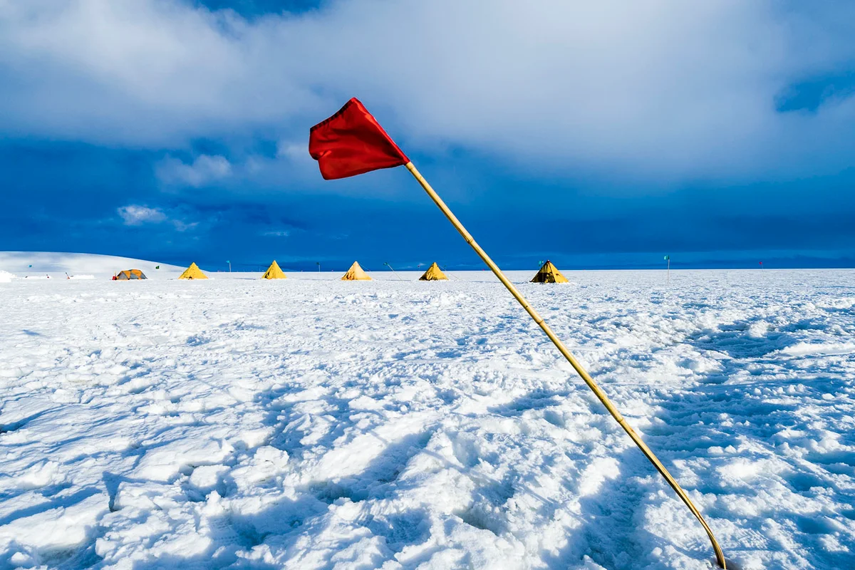 A red flag bending in the wind the amount of bend indicates the wind speed