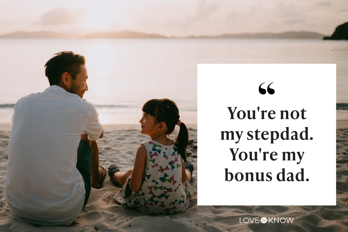 Father and daughter sitting on beach and looking at each other at sunset