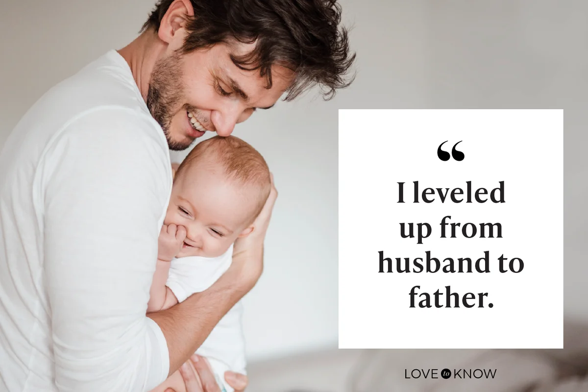 Father holding baby girl at home