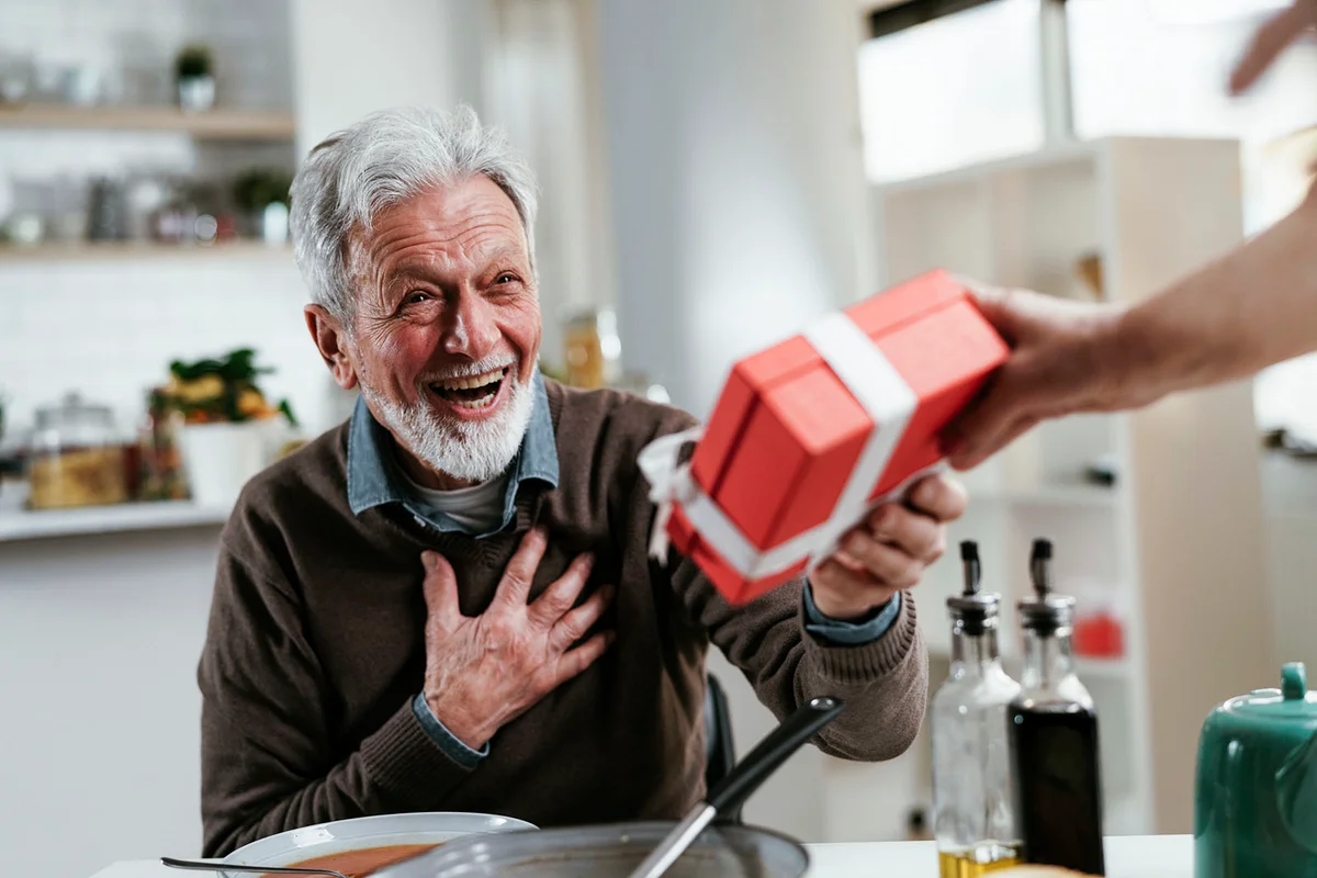 Portrait of senior man with gift