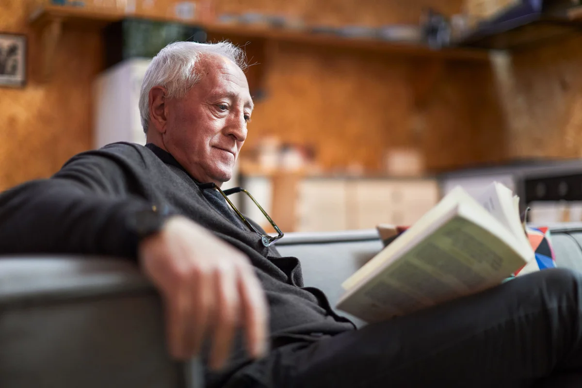 A senior man is reading a book