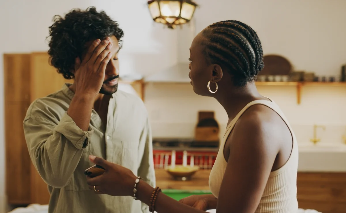 Woman asking man about something on his phone