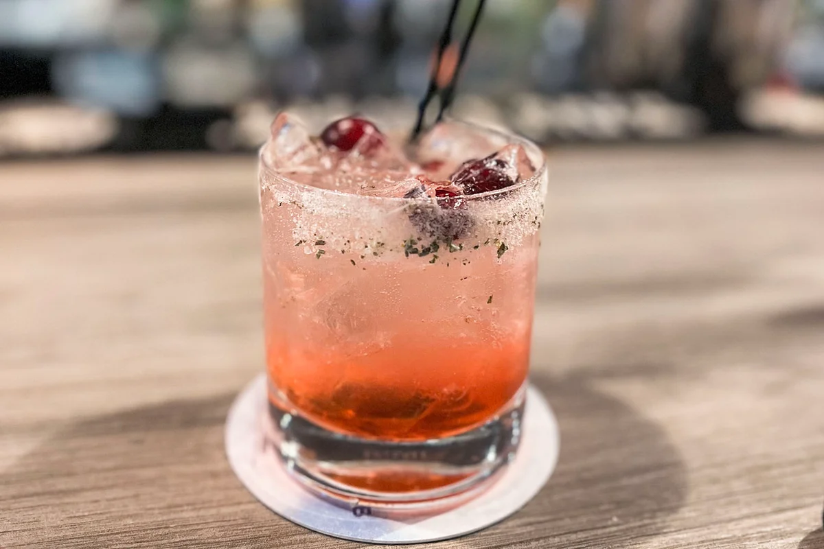 Cocktail with cranberry garnish