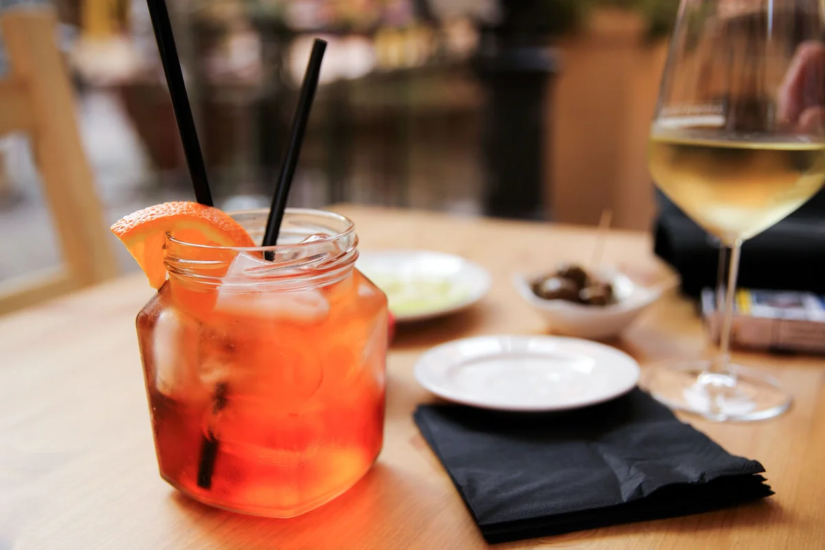 Two drinks on a table at happy hour