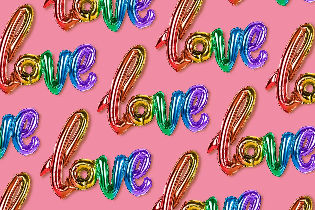 Rainbow LOVE balloons on pink background