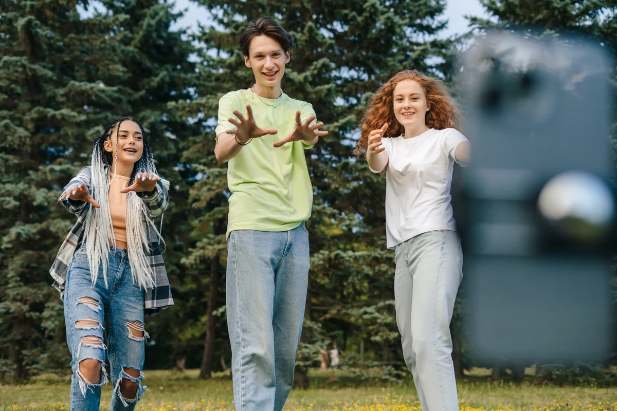 Boy with two girl blogger recording content for their social networks with a mobile phone