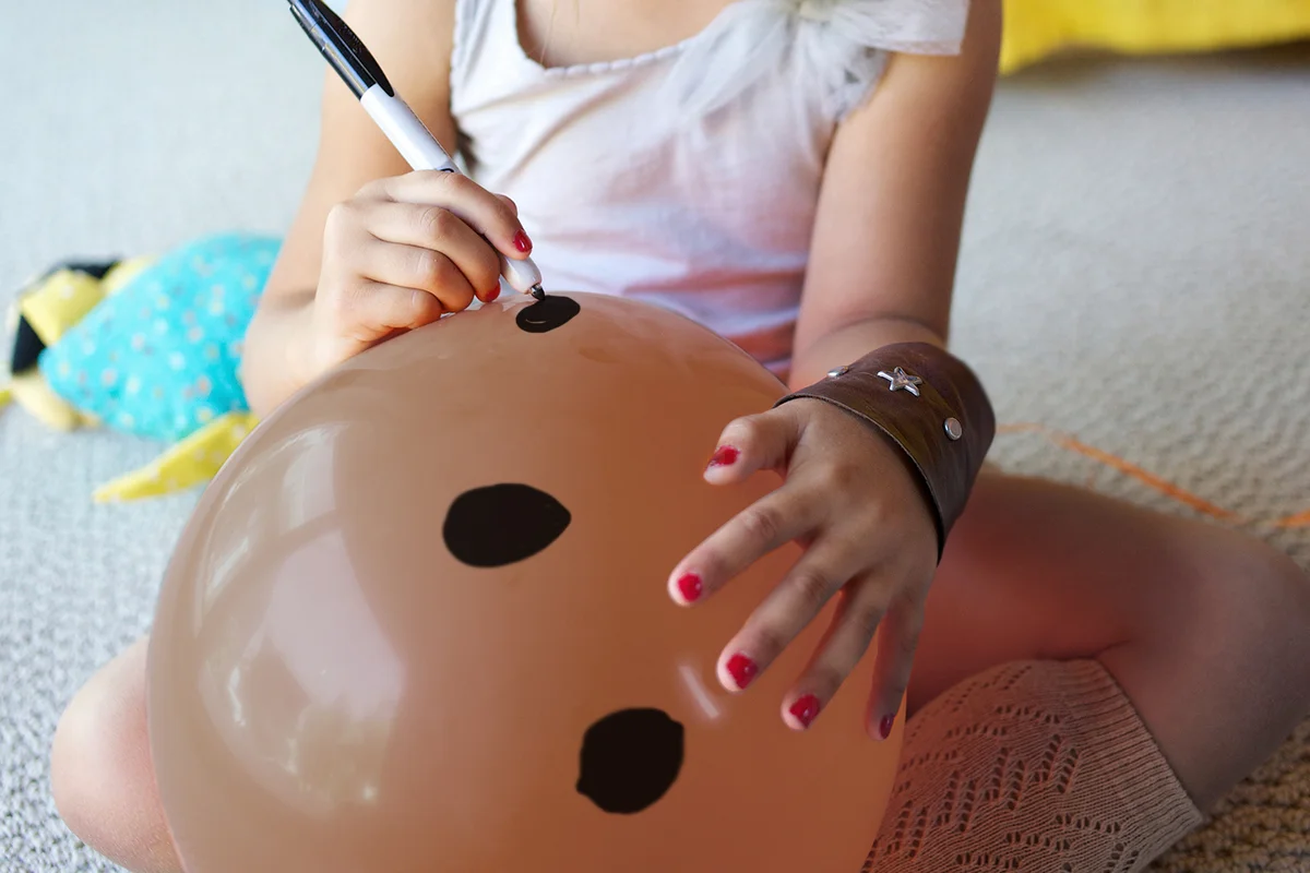 girl drawing on balloon