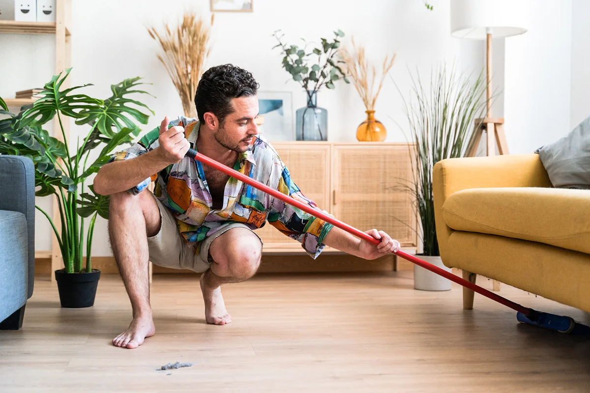 Man cleaning the floor with broom