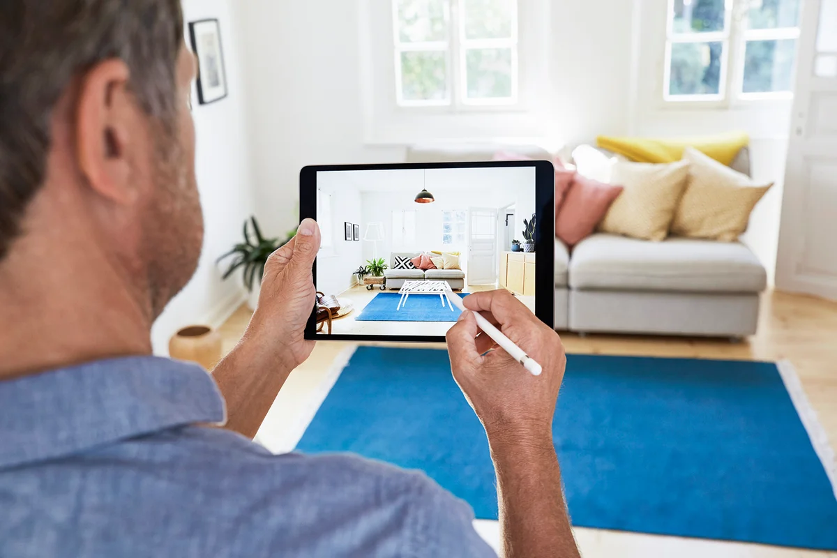 Mature man designing modern living room in a virtual reality