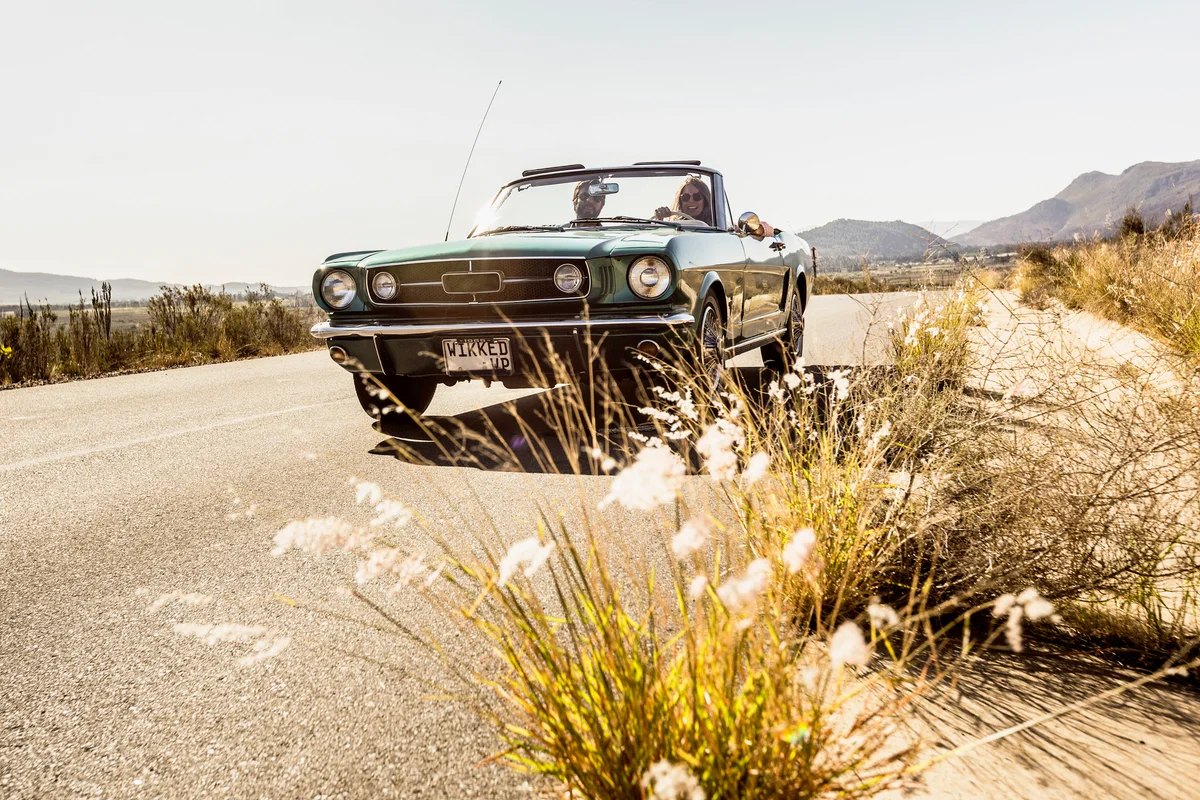 Couple in classic convertible car