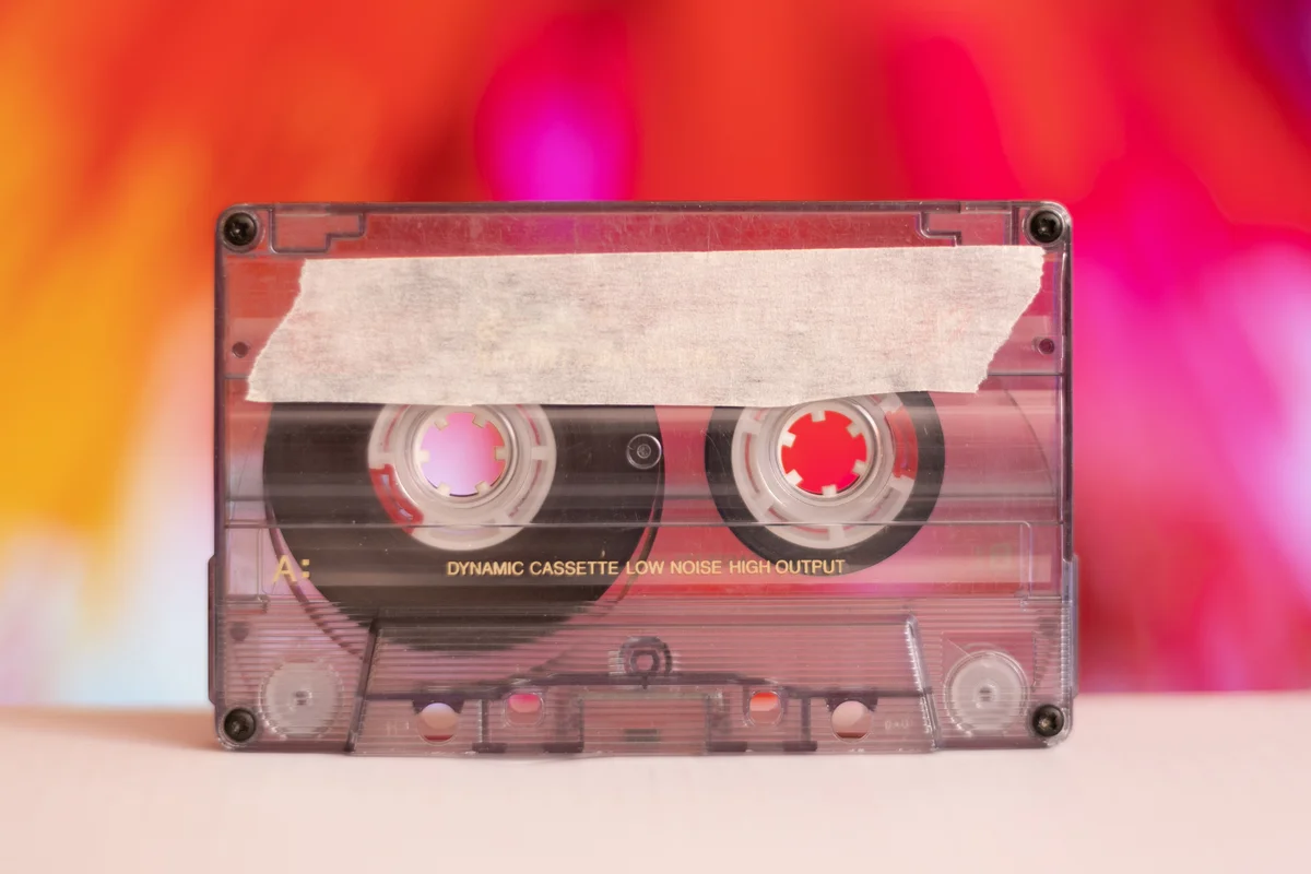 Retro cassette tape on colorful background