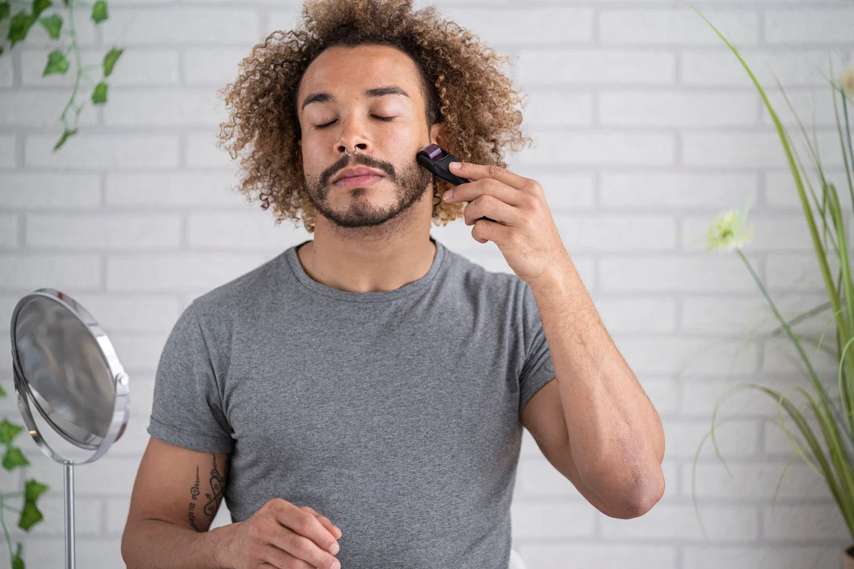 man using a derma roller