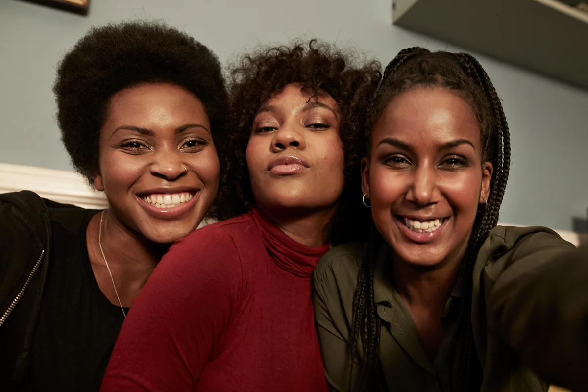 Three young women making selfie in sofa at home