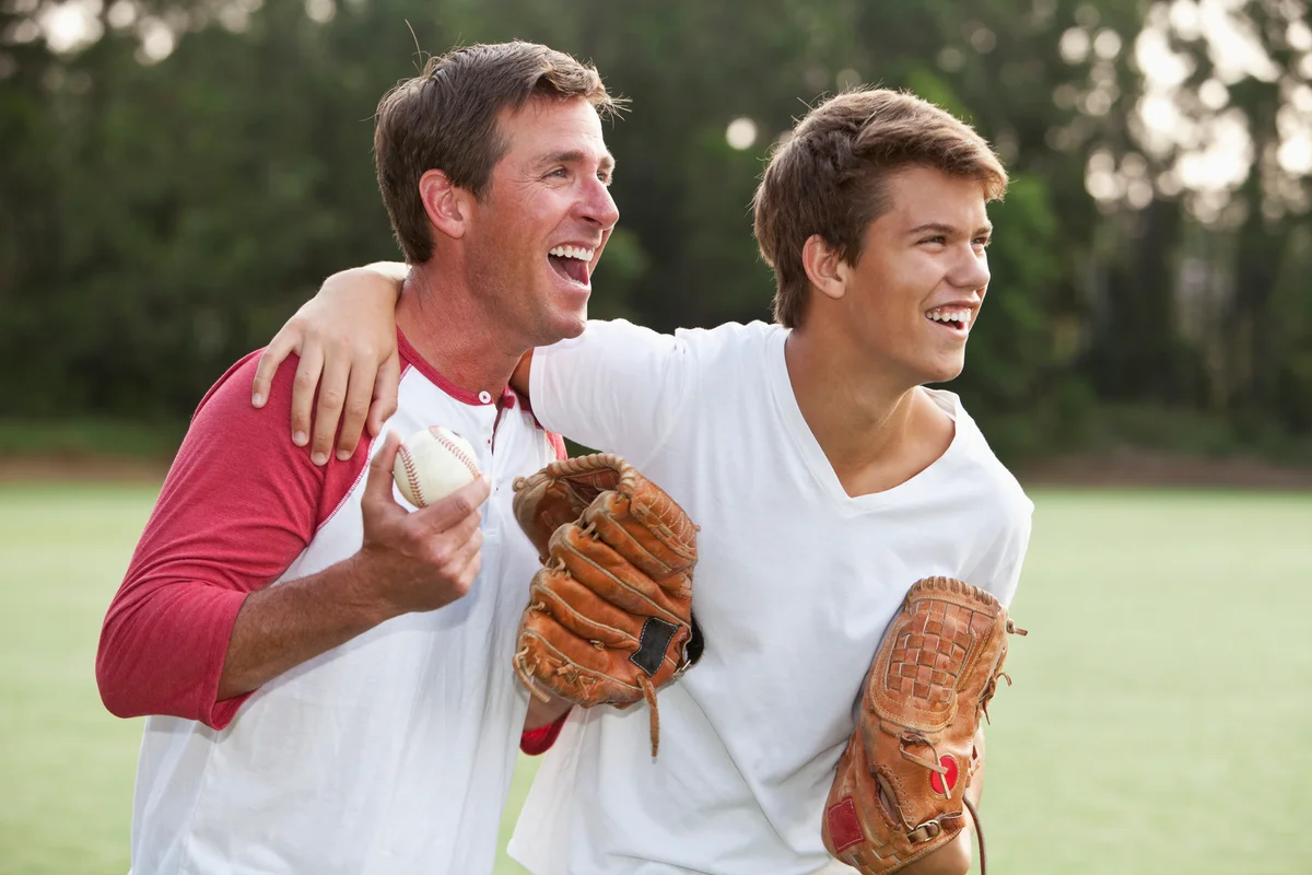 teen and dad playing baseball