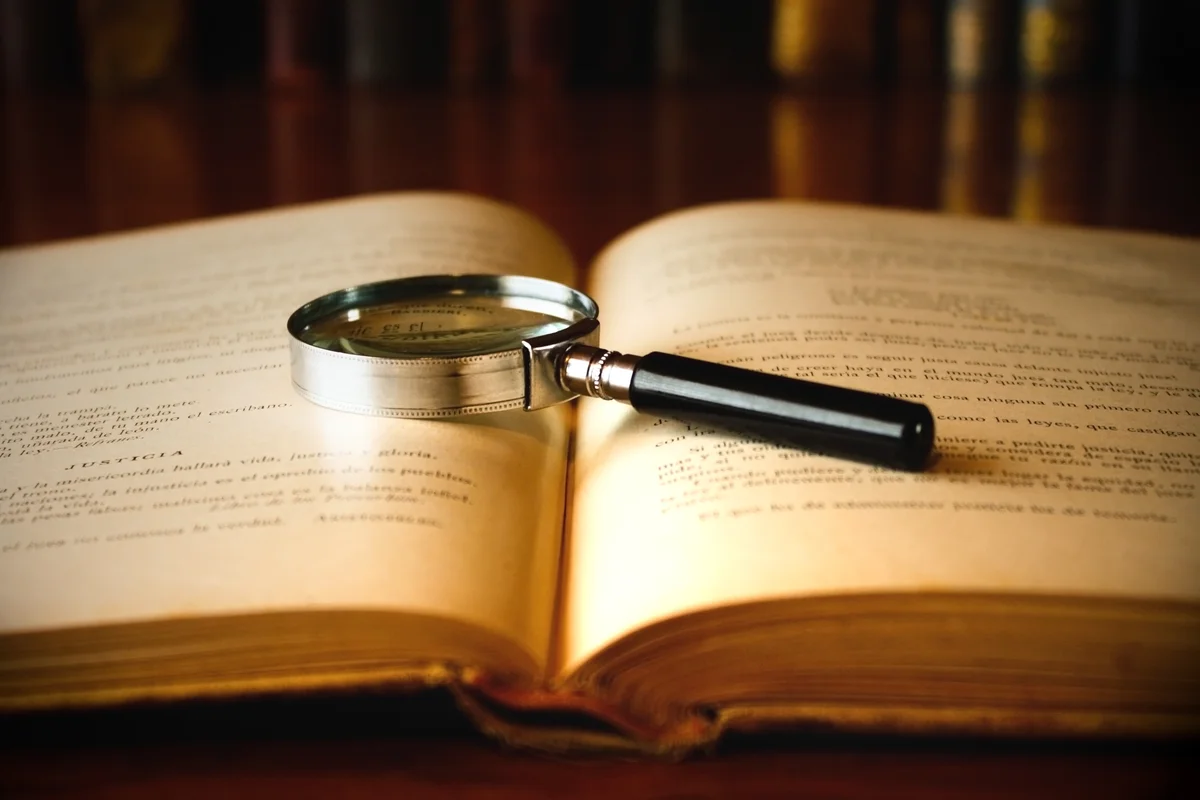magnifying glass and vintage book