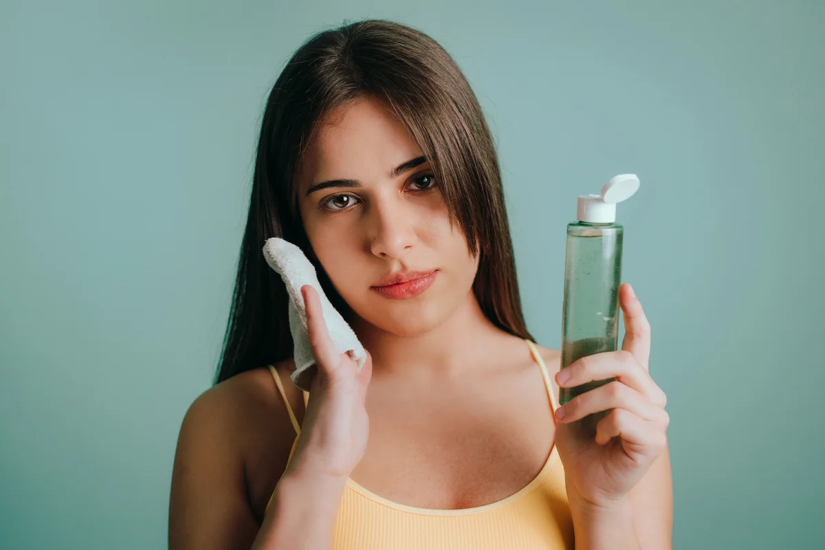 woman removing makeup with reusable cotton cloth