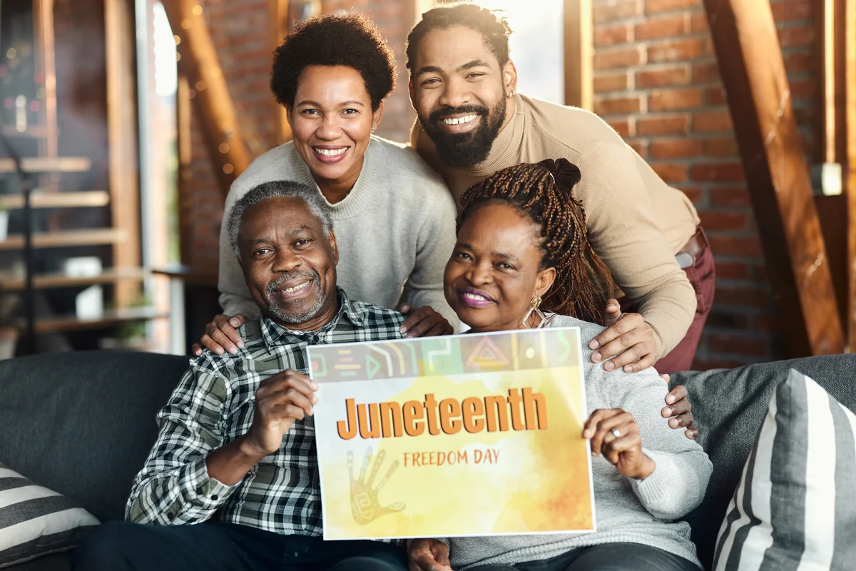 family with Juneteenth sign