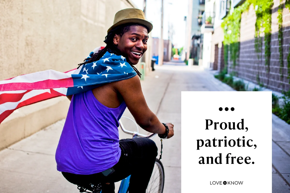 A young man with an american flag around his neck