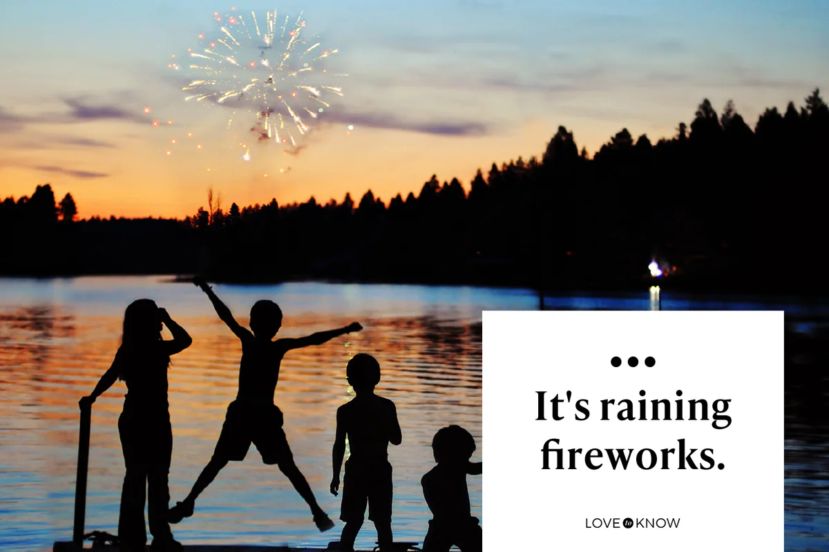 Kids jump and cheer as they watching fireworks from dock at lake in Montana.