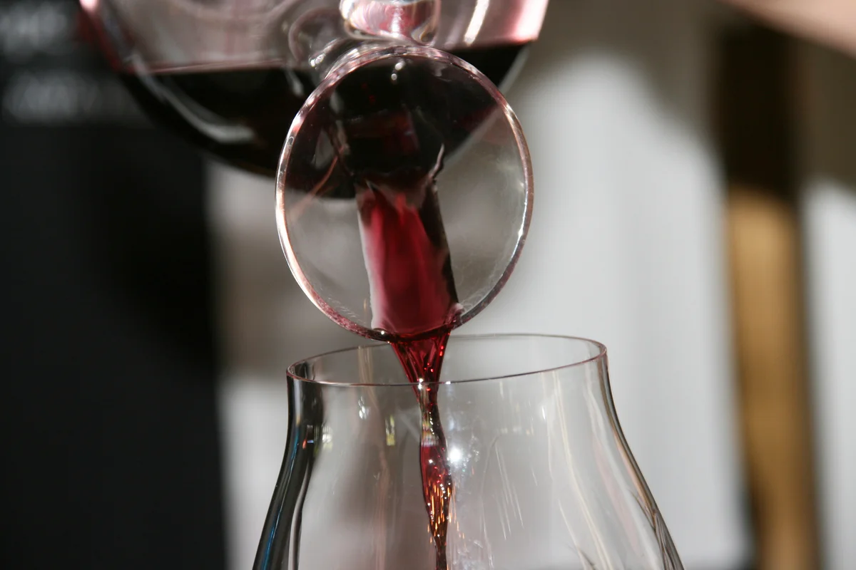 pouring red wine from a decanter