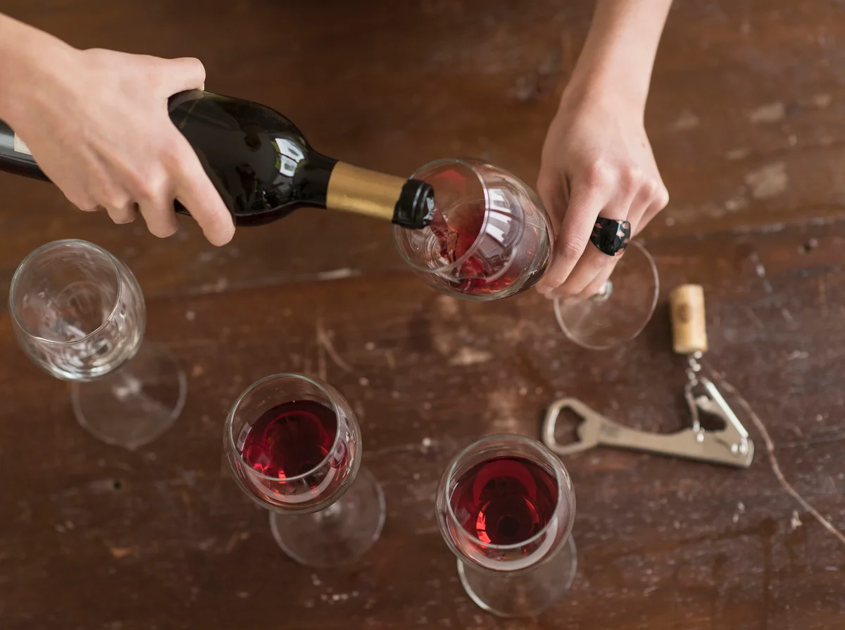 Pouring sangiovese into glasses