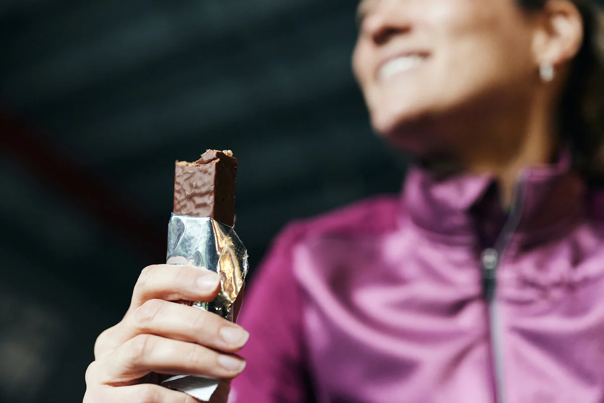 woman eating protein bar