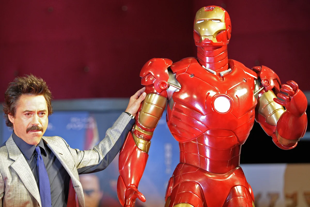 Robert Downey Jr. poses by a life-size Iron Man model - Getty Editorial