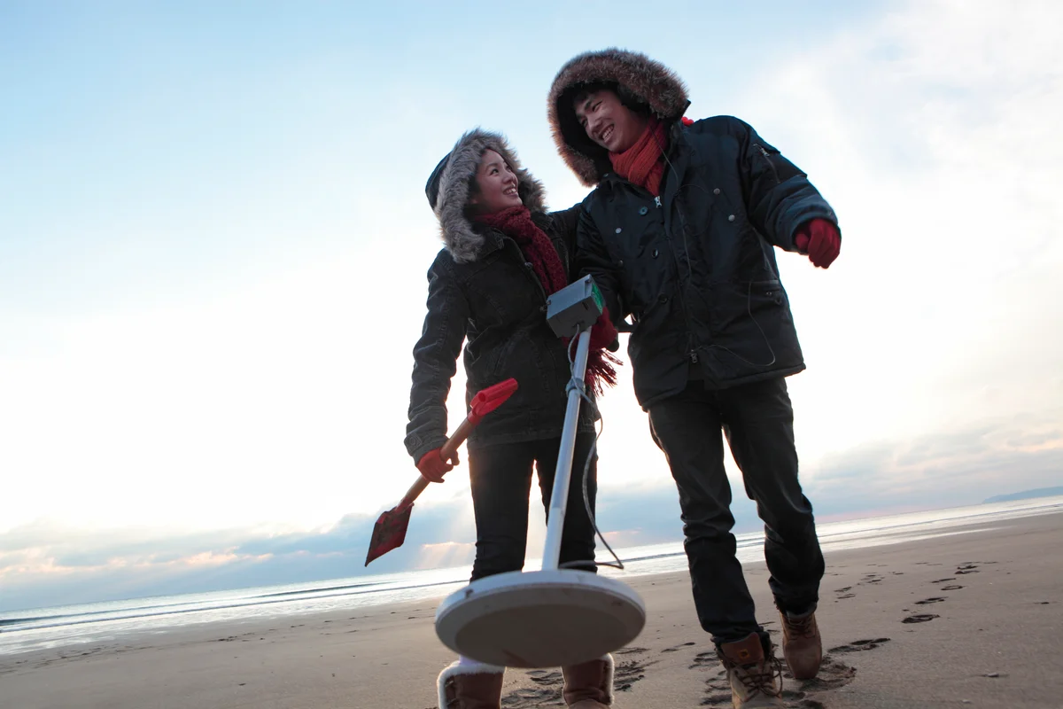 happy couple metal detecting