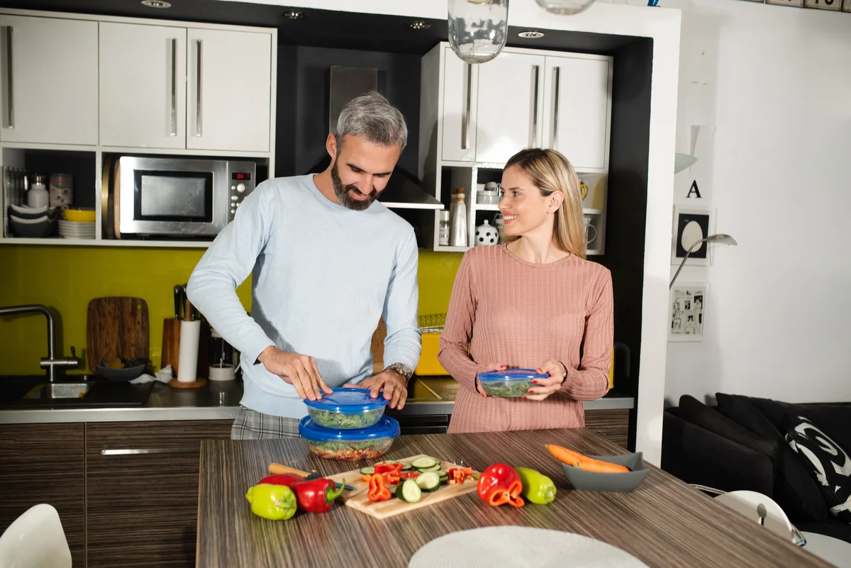 couple packing lunches together