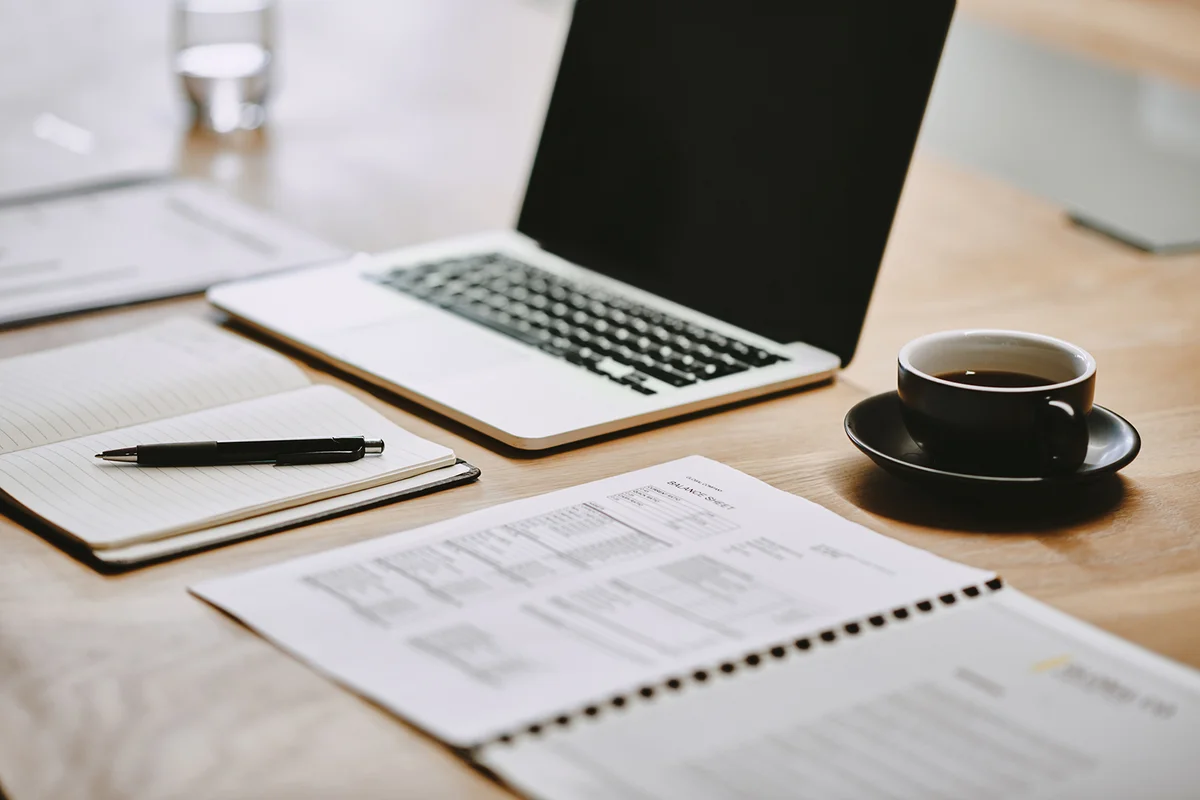 Shot of a notebook and laptop in an office