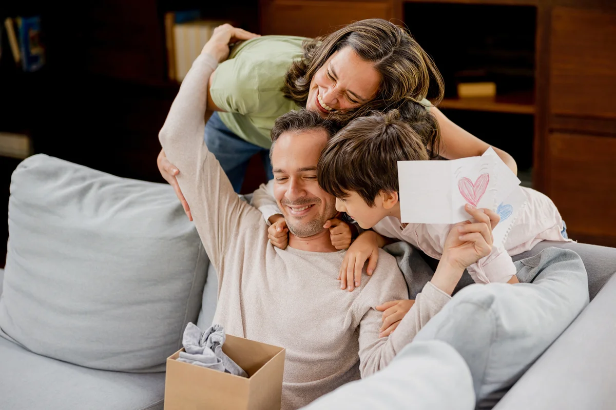 Happy father opening his gift for Father's Day