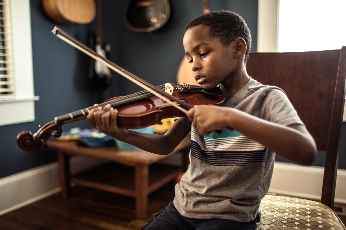 Young boy practicing violin