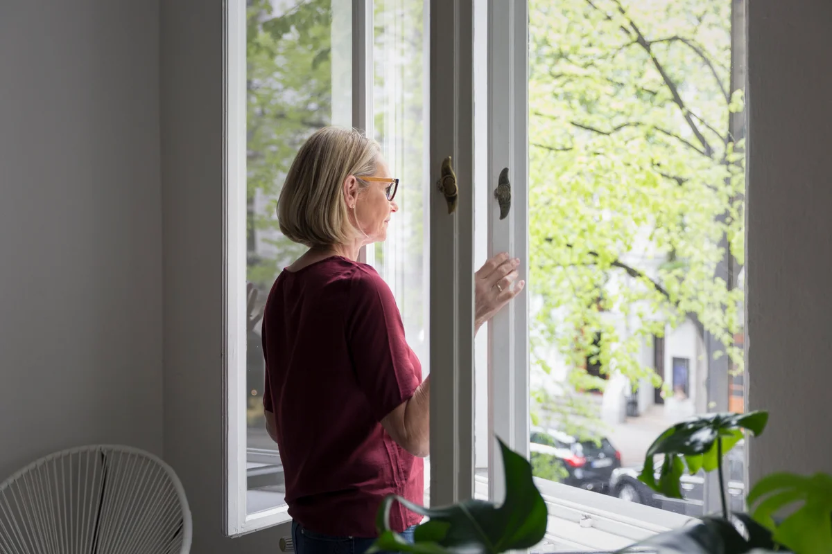 woman opening a window